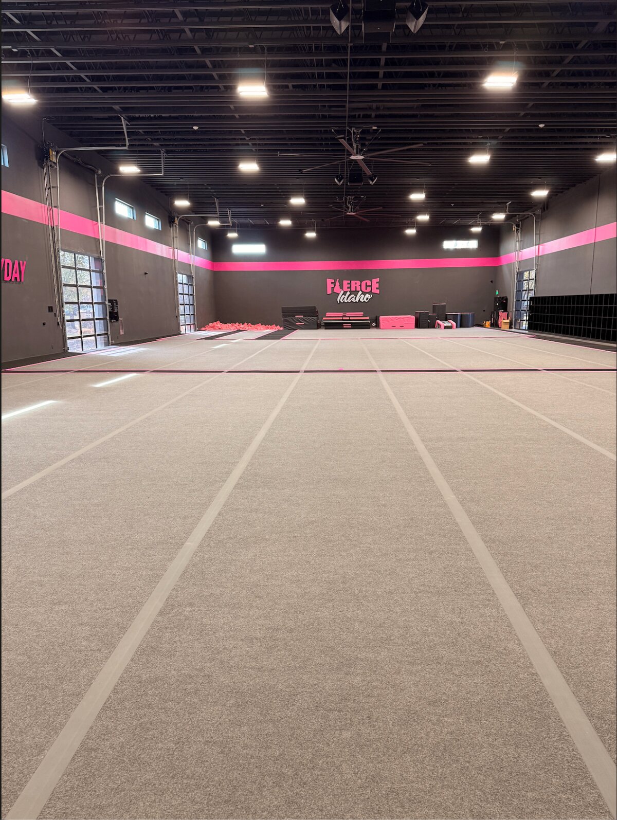 The main Fierce Idaho gym with full cheer floors under pink-striped walls